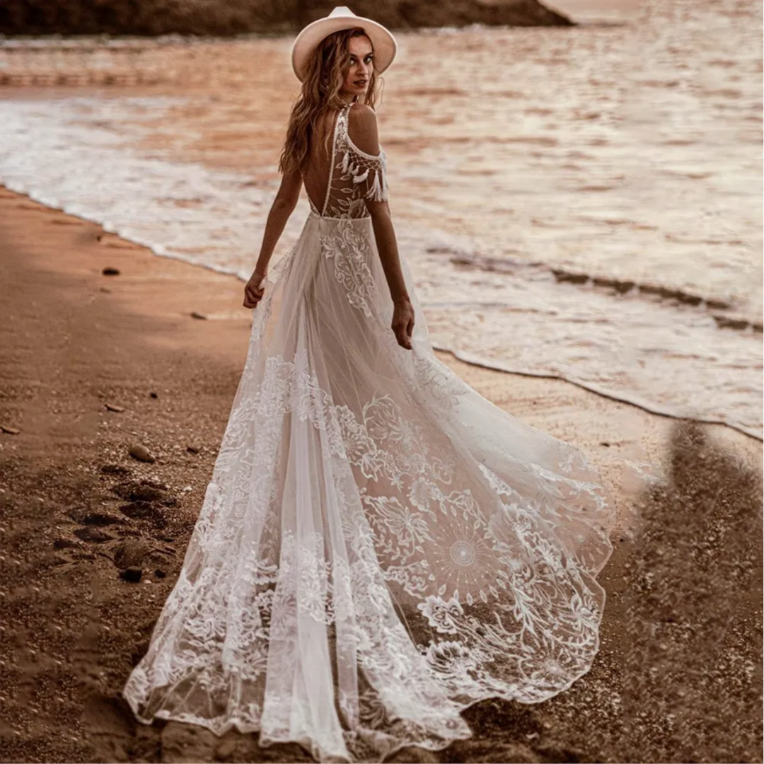 Boho-meets-modern bridal gown: V-neck, embroidery, open sides, low back, lace & A-line silhouette.