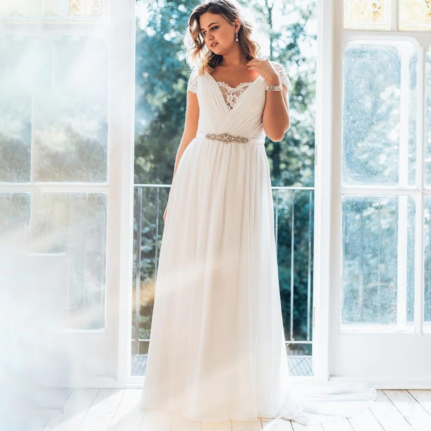 Beautiful Ruched Chiffon A-Line Wedding Dress with Lace panel, Cap Sleeves, Gorgeous Rhinestone Sash Belt and Lace & Button back. In White. - Bella Grace