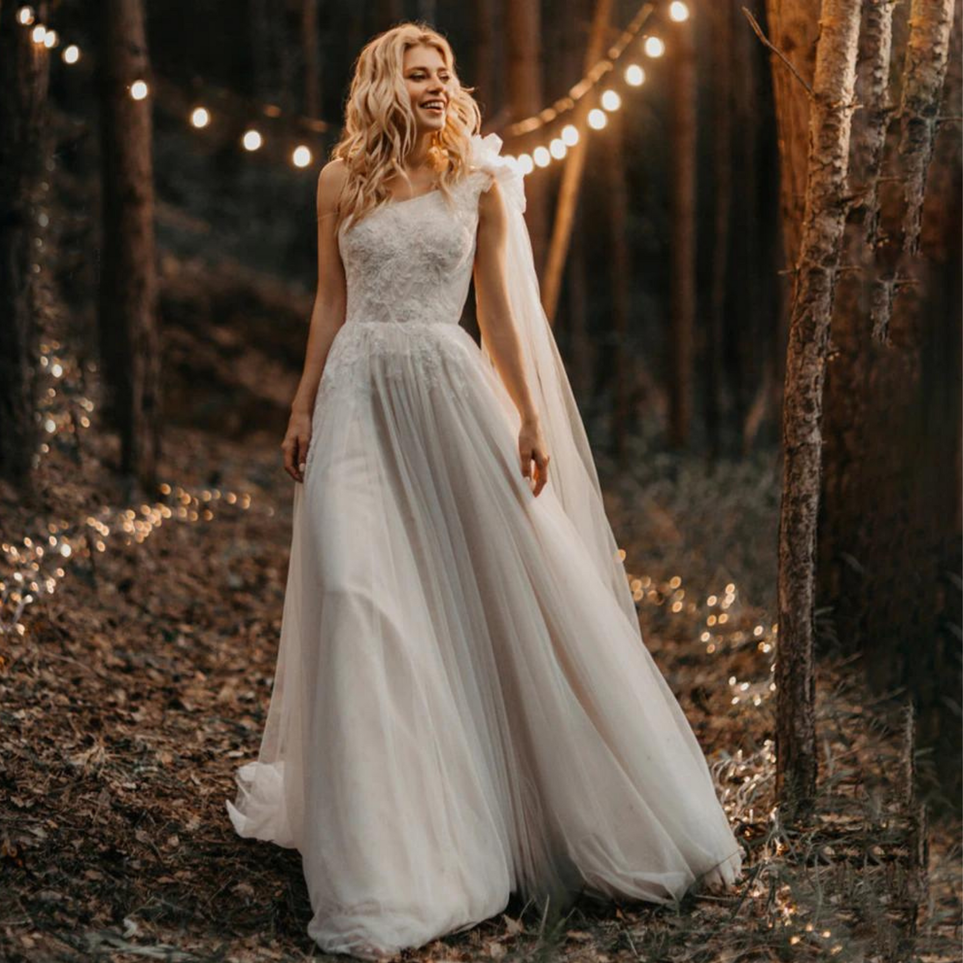 One-shoulder boho wedding gown: ruched bow, lace & tulle, A-line, built-in bra, sweep train.