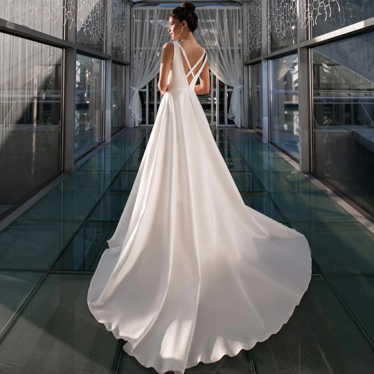 Beautiful simple sleeveless A-Line gown for Wedding Bride Beach in Satin, with deep V neck and backless crossover design. In White. - Bella Grace