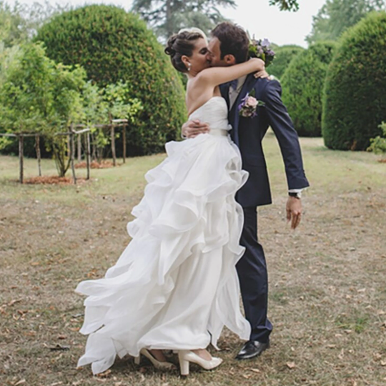 Amazing Strapless Organza Cascading Ruffled Bridal Gown with Cream Satin Tieback Waistband -  In White. - Bella Grace